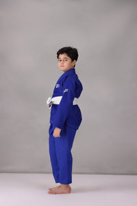 Child wearing a custom kids Jiu Jitsu Gi in the UK, blue Brazilian Jiu Jitsu uniform with a white belt on a gray background