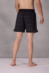 mens mma shorts uk Black patterned worn by a person