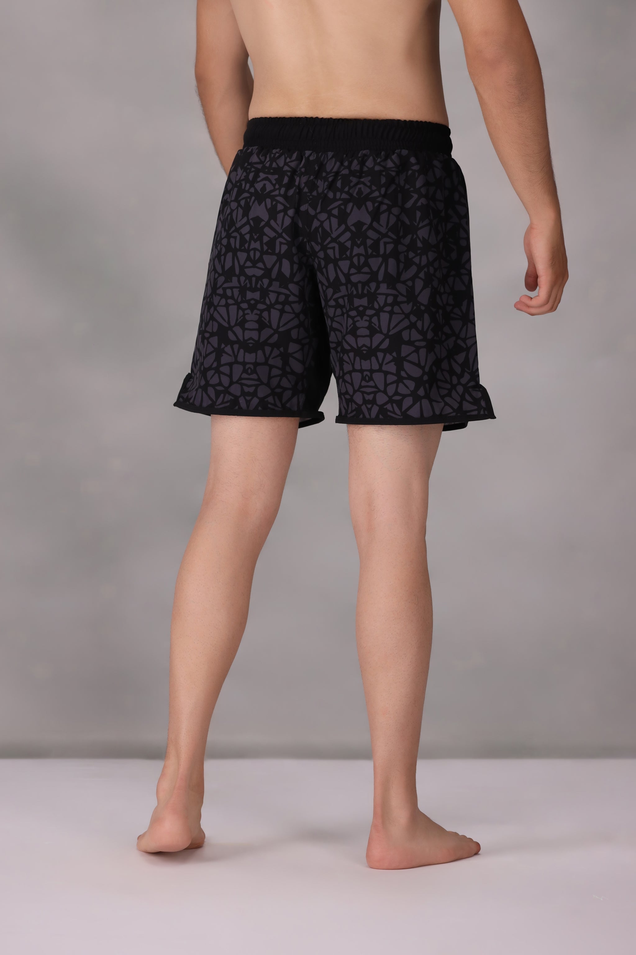 mens mma shorts uk Black patterned worn by a person