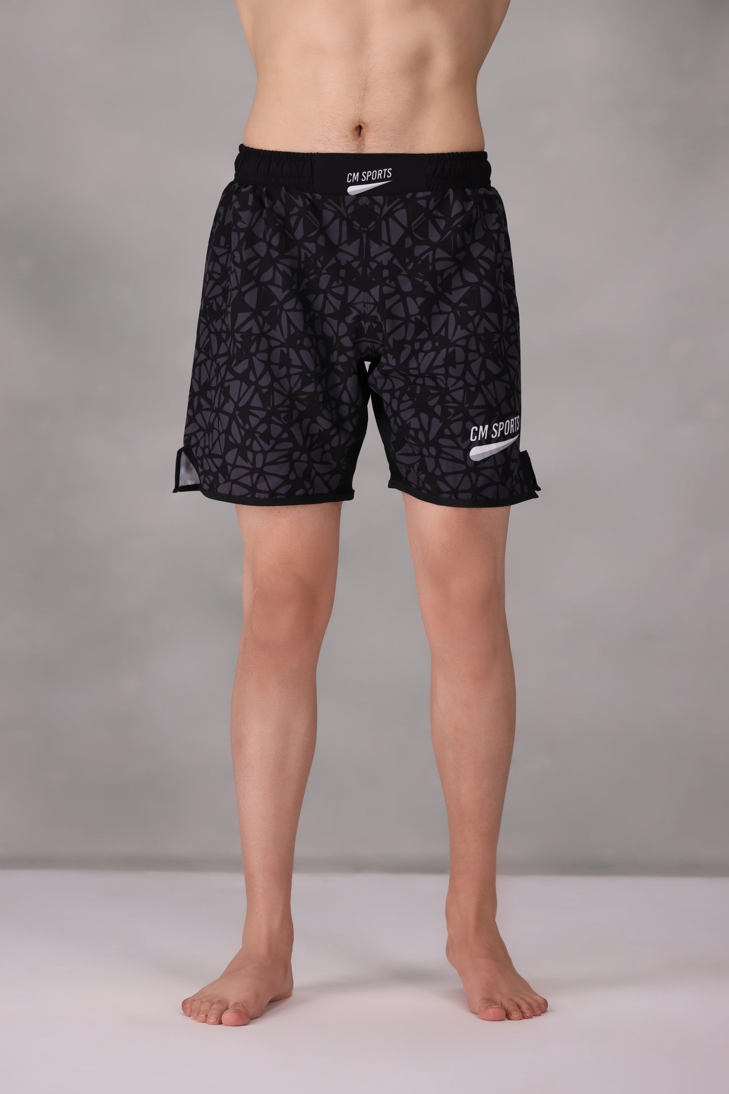 Black patterned mens mma shorts uk worn by a person
