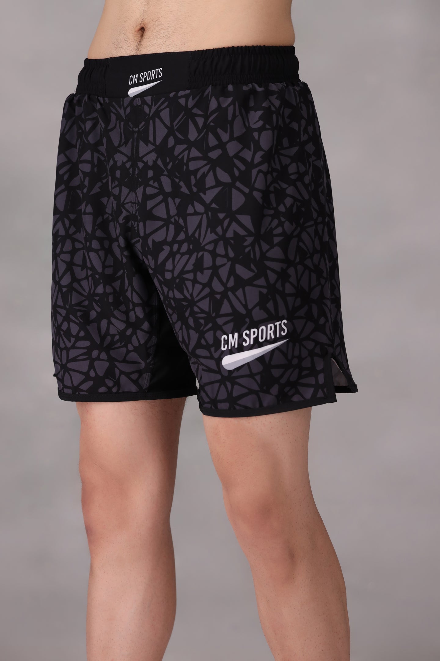 Black patterned mens mma shorts uk worn by a person