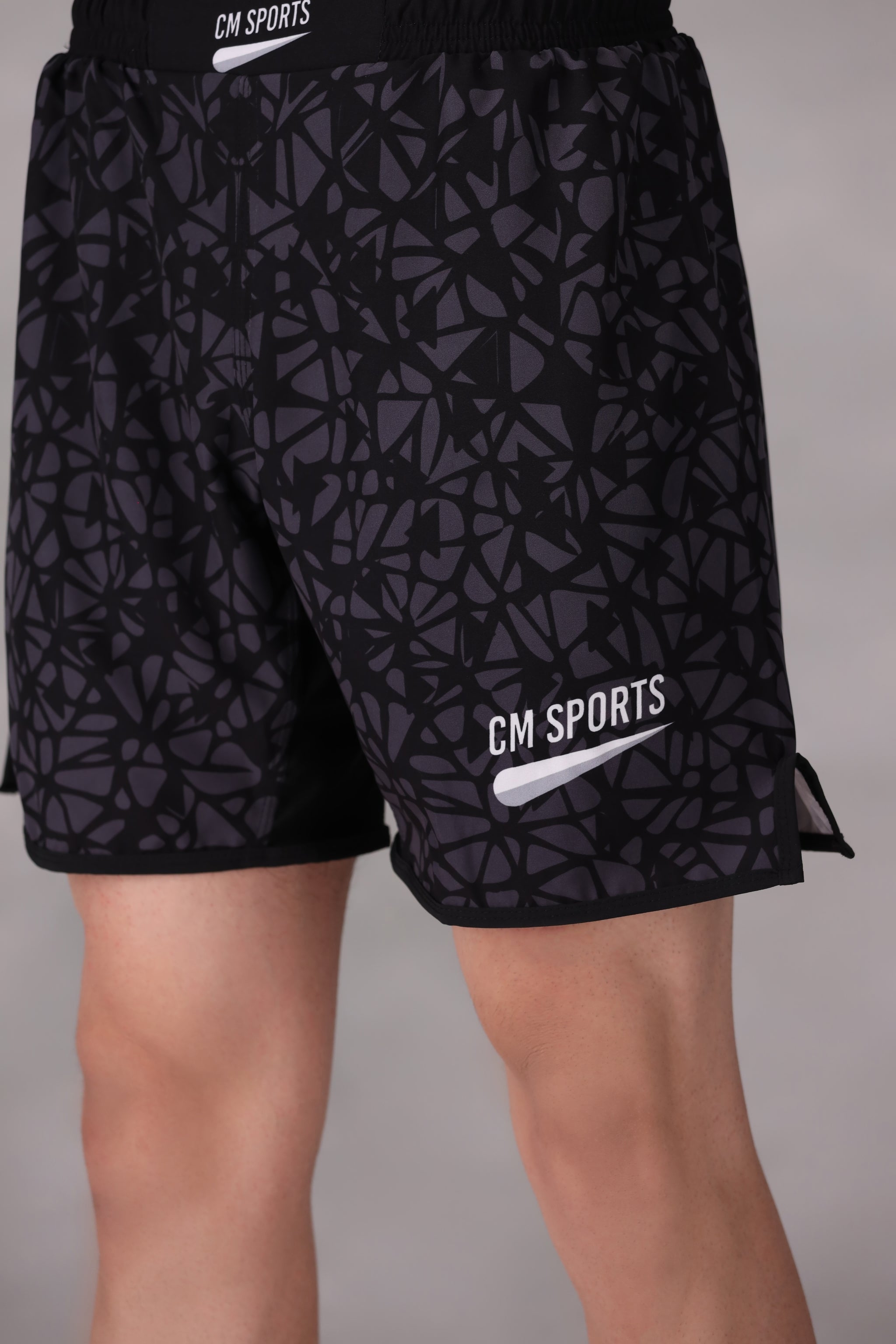 mens mma shorts uk Black patterned worn by a person