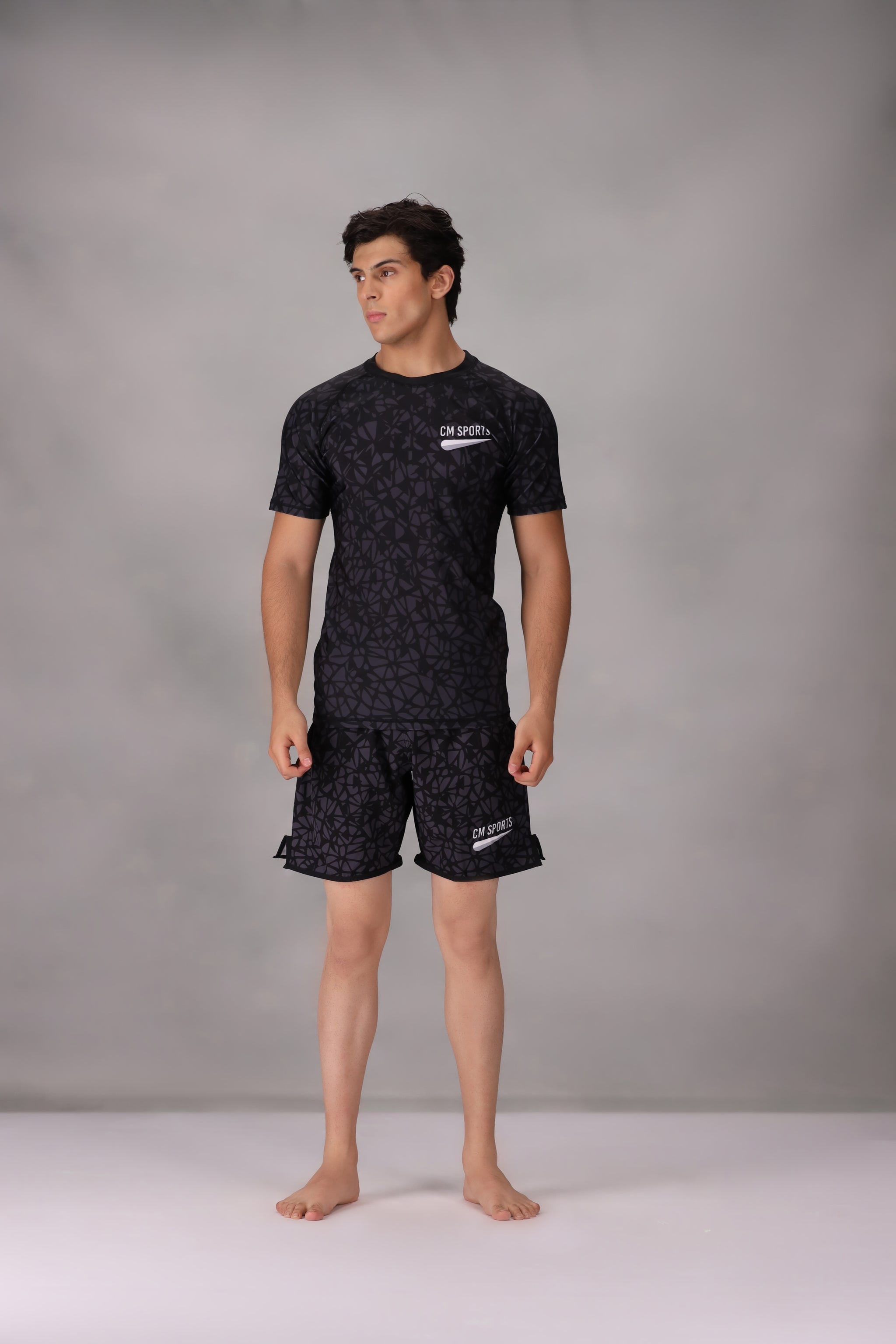 mens mma shorts uk Black patterned worn by a person