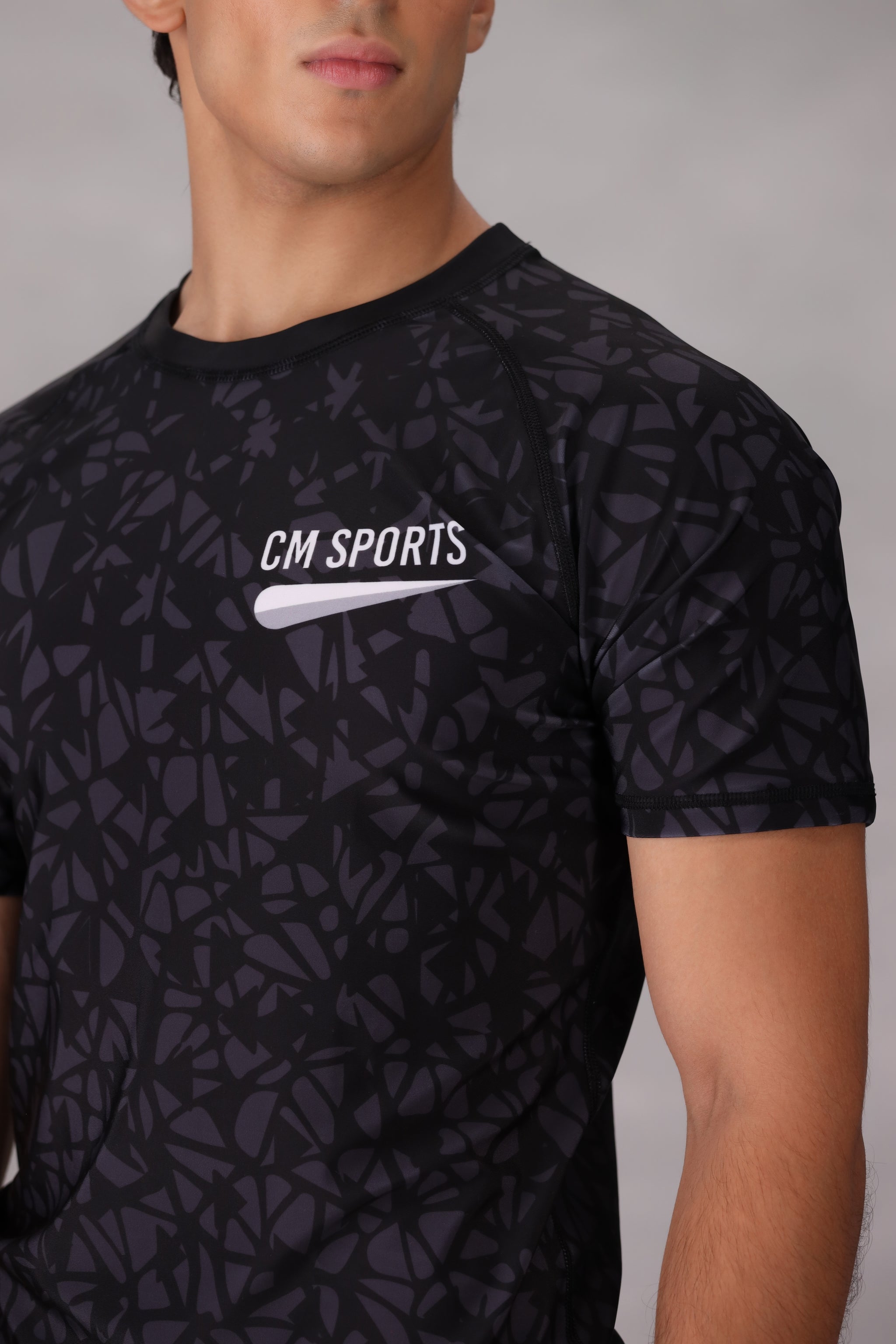 Black patterned mma rashguards for men bjj uk sports shirt with 'CM Sports' logo on a gray background