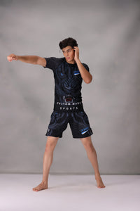rash guard bjj men wearing a black sports outfit with cm sports with gray background