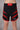 personalised mma shorts uk Black and red athletic shorts on a plain background